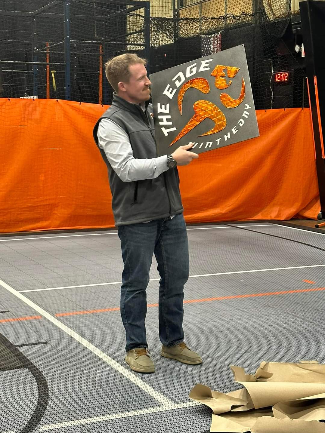 Layered custom metal fitness logo sign for The Edge displayed inside a training facility