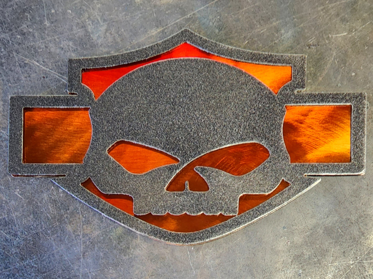 Orange automotive emblem with skull by Elite Metalworking