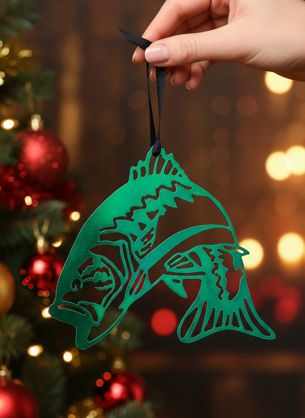 A green metal ornament in the shape of a large mouth bass with intricate details, hanging from a black string.