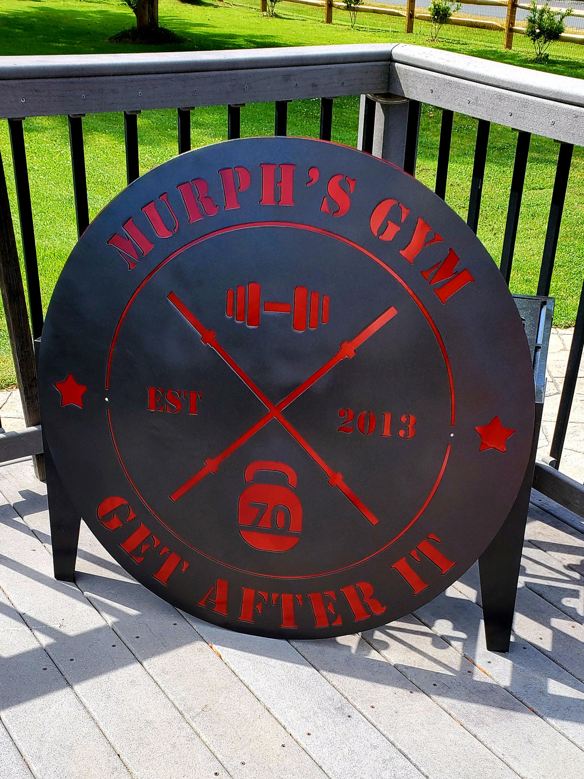 Round black and red custom metal sign for Murphy's Gym