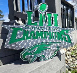 Green football championship artwork displayed outside by Elite Metalworking