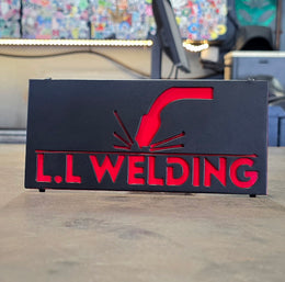L L Welding black and red hitch cover by Elite Metalworking