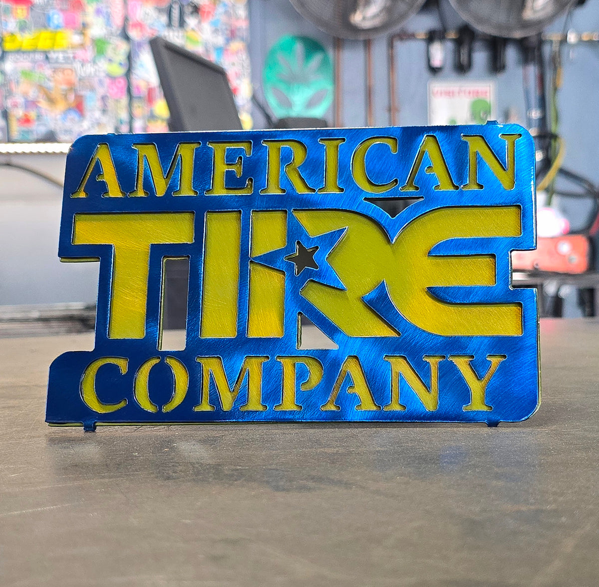 American Tire Company custom steel hitch cover in blue and gold