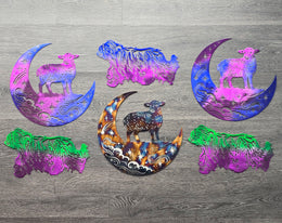 Colorful dog-themed metal art and moon designs arranged together by Elite Metalworking