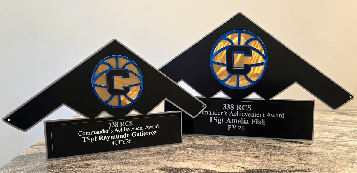 Two triangular military achievement awards with circular emblems by Elite Metalworking