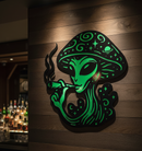 Glowing green alien design on a wooden wall