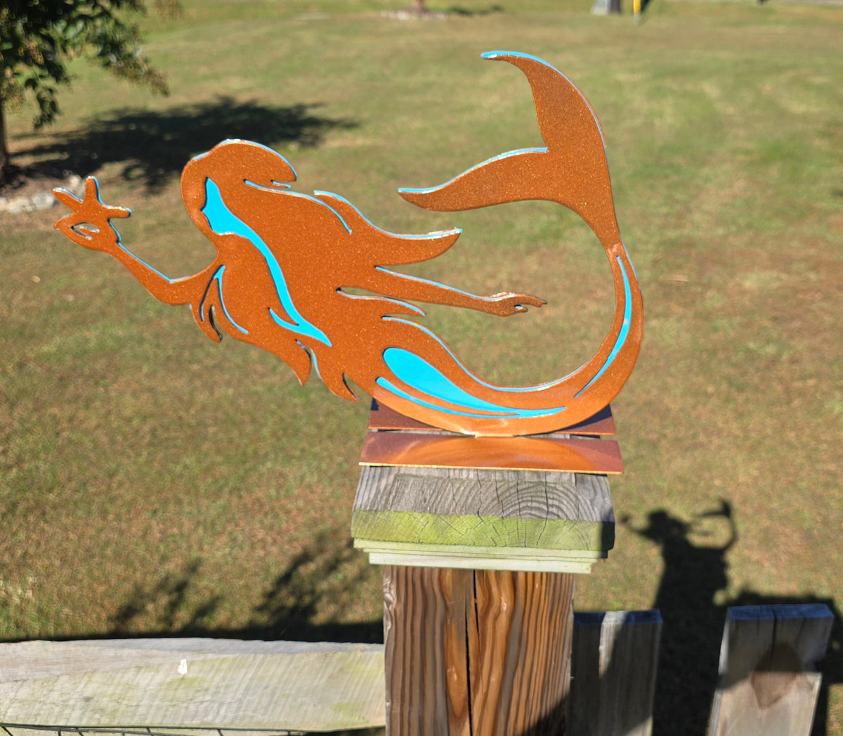 Orange mermaid fence topper by Elite Metalworking