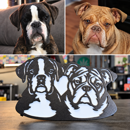 Original boxer and bulldog photographs above their finished two-dog custom metal hitch cover with a heart between the portraits