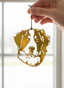 A decorative metal ornament in the shape of a Bernese Mountain Dog with a multicolored, powder-coated finish.