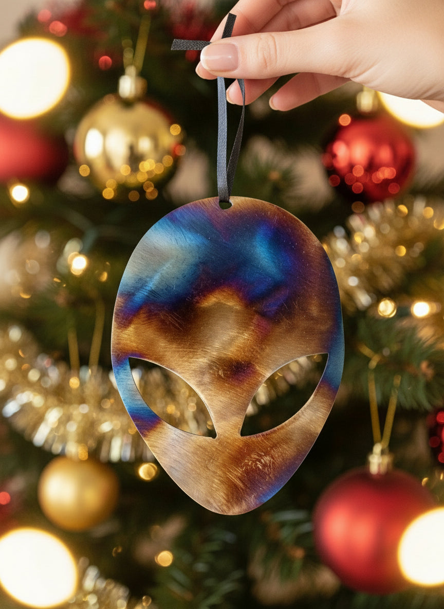 A metal ornament in the shape of an alien with a powder-coated finish, featuring a multicolored design.